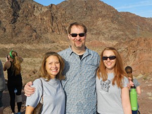 Dr. Bartelink, Dr. Baker, and Dr. Latham smiling for a picture infront of a mountainous background
