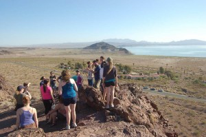 Many people on top of a rock hiking