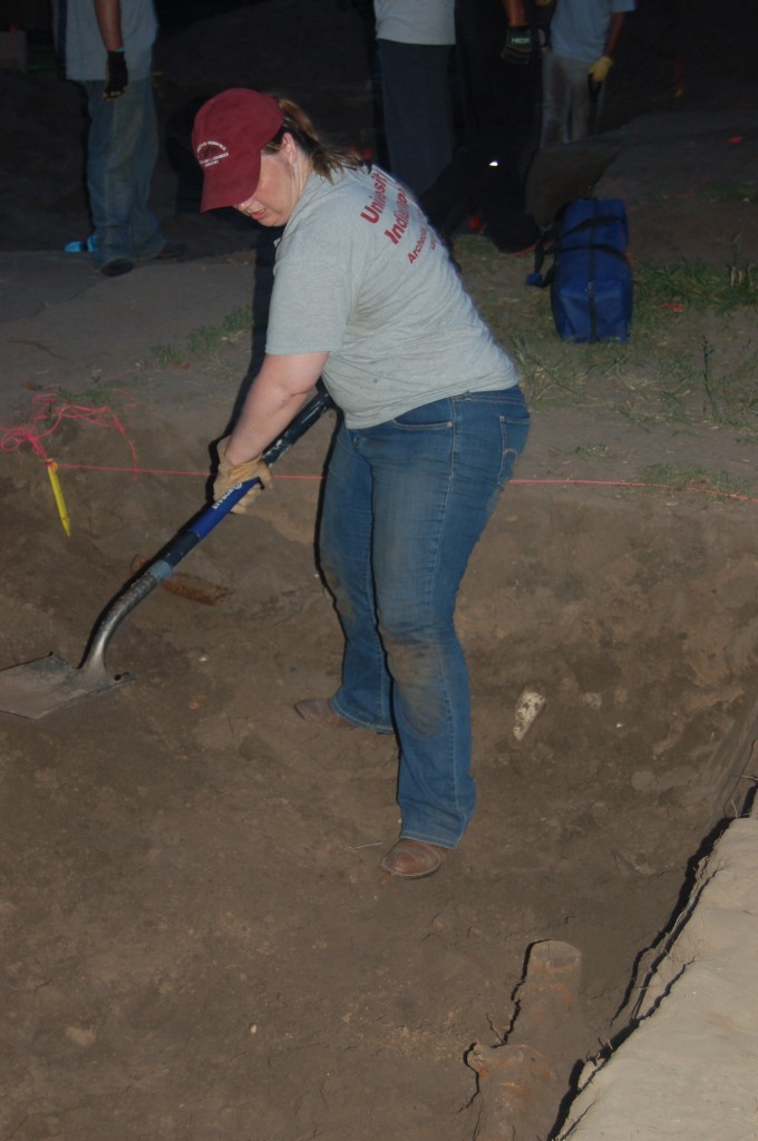 Jessica removing burial fill with a shovel