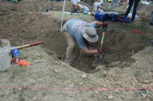 Erica digging in a burial with a shovel