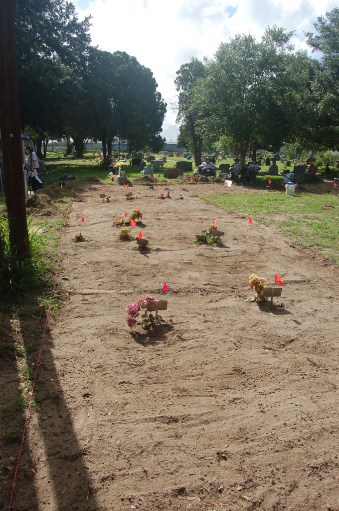 The same burial area with burial markers still in place but all grass removed