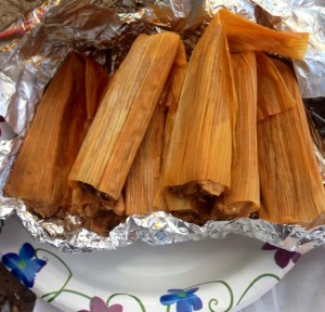 Plate full of tamales in corn husks