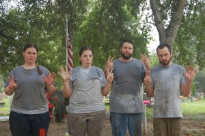Day 7 group photo with 7 fingers up, all frowns, and drenched shirts 