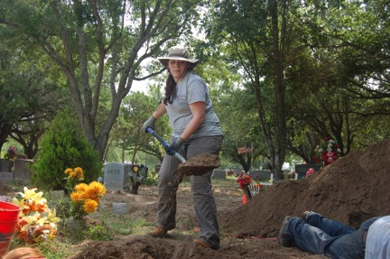 Team member Erica digging with a shovel