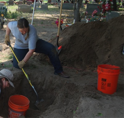 Team member Jessica digging with a shovel