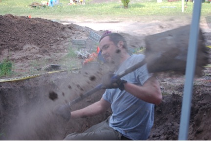 Team member Ryan digging with a shovel
