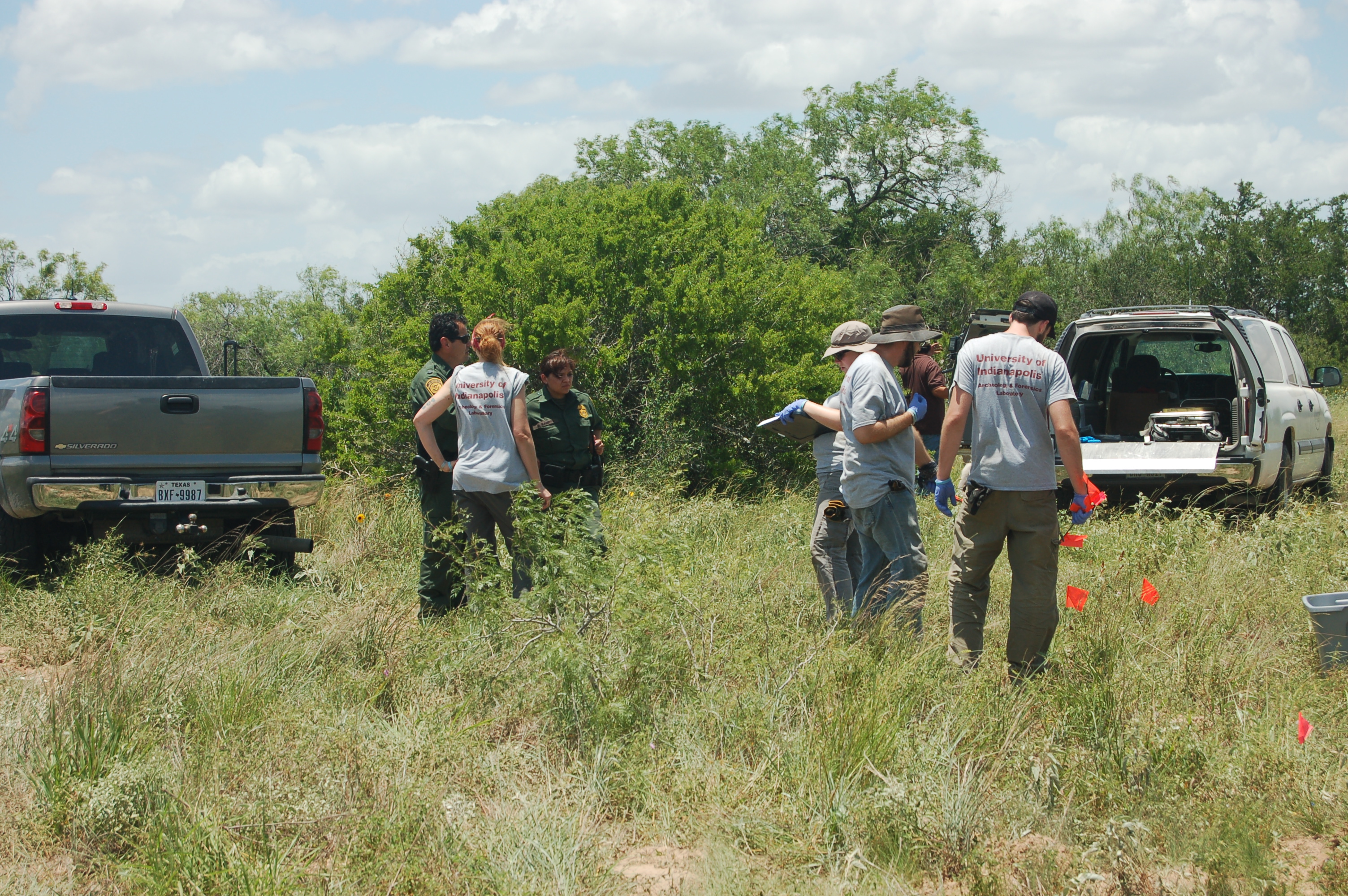 Uindy team members in the brush talking to Border Patrol