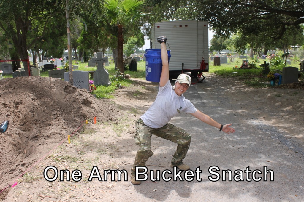 Team member squatting holding a bucket in their hand, their arm fully extended up