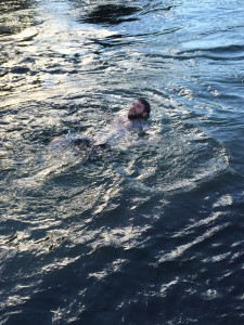 Team member Justin swimming in the river