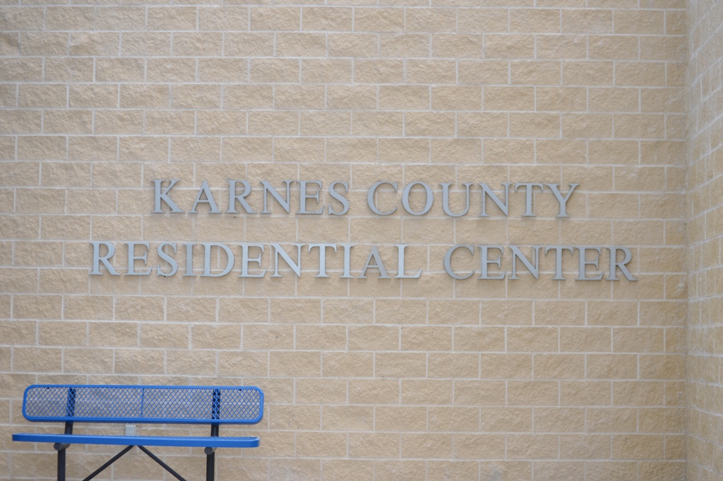 Karnes County Residential Center lettering on a beige brick wall