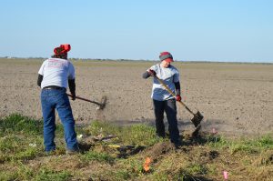 Jordan and Jessica digging a trench