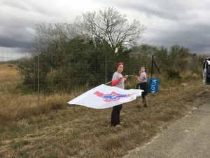 Angela, Arianna, and I raising a new flag at a water station