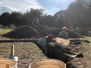 Team members digging trenches