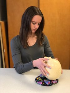 Team member Megan holding a skull