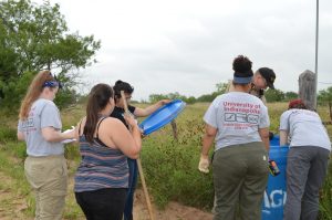 Team members filling a water station