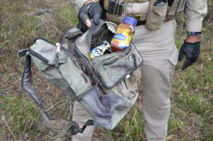 (Sheriff Deputy Don White holding backpack) 