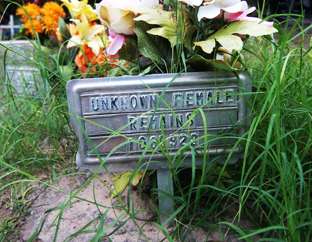 Metal grave marker reading "Unknown Female Remains"