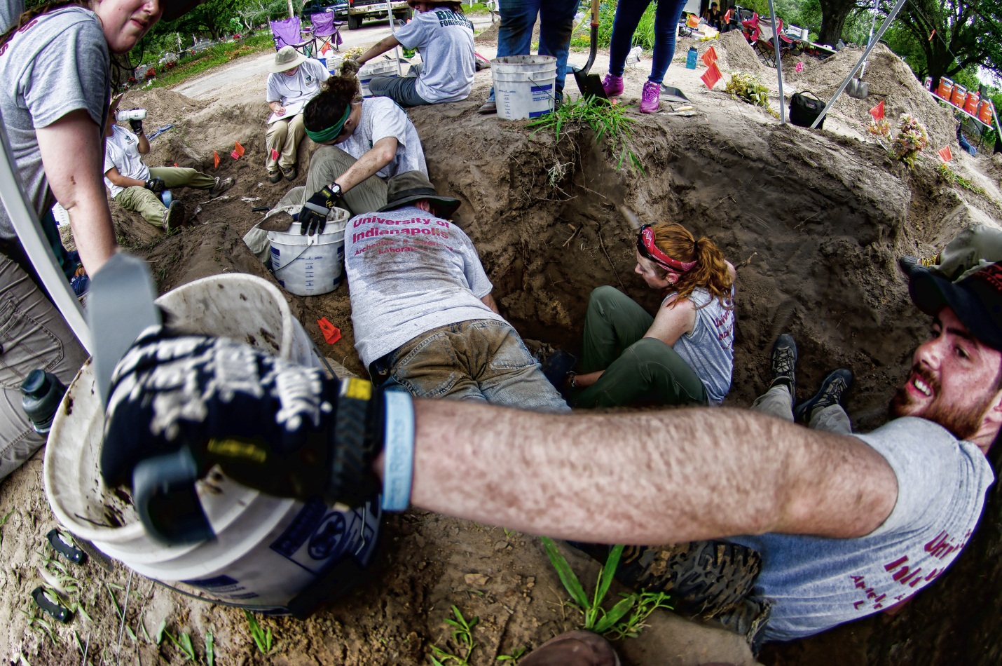Beyond borders team members within a burial excavating in various positions 