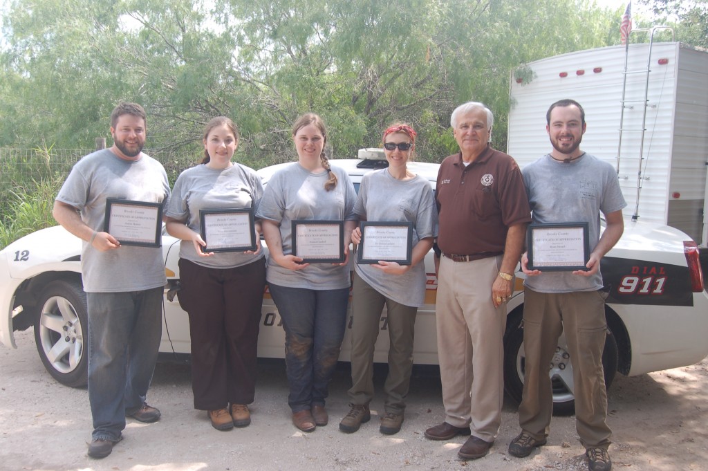 The beyond borders team with Brooks County Judge Ramirez while holding up Certificates of Appreciation from Brooks County