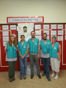 The UIndy family and Sister Pam at Sacred Heart Church wearing teal caution vests