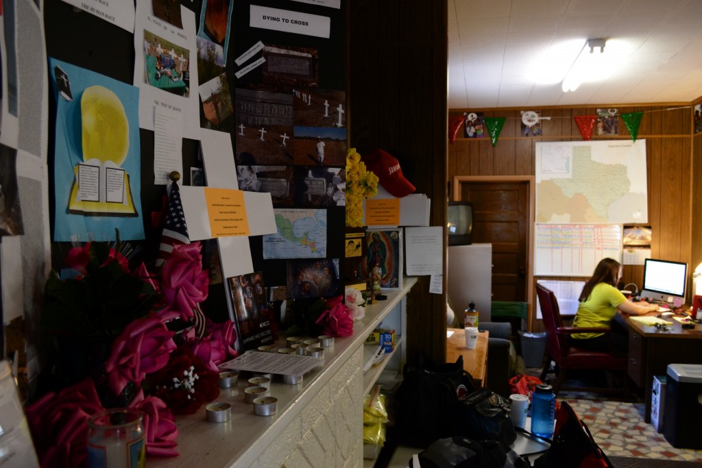 Colorful Decorations and posters on a mantle near a workstation in the South Texas Human Rights Center