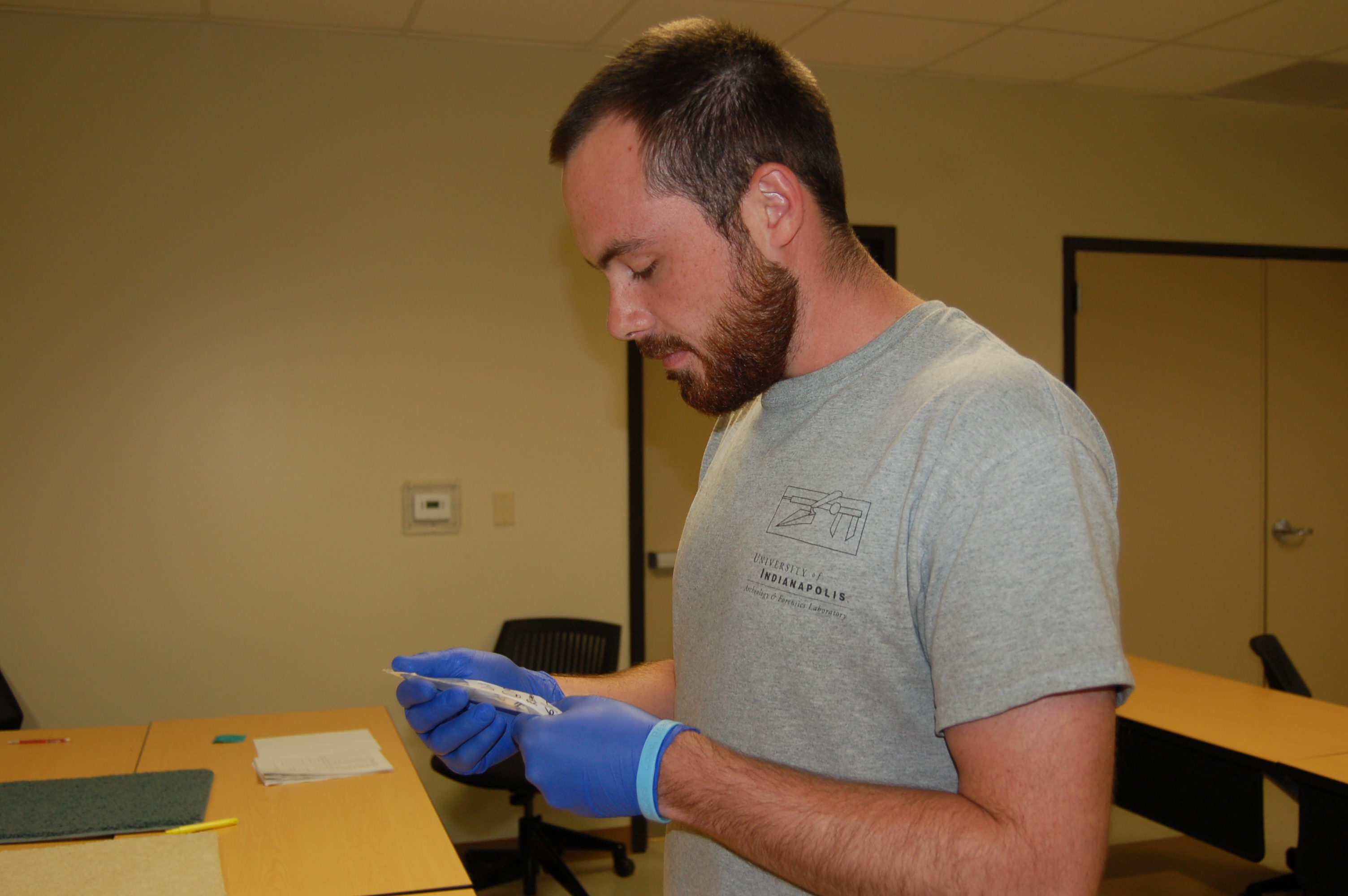Team member handling a swab with gloves on for DNA sample collection