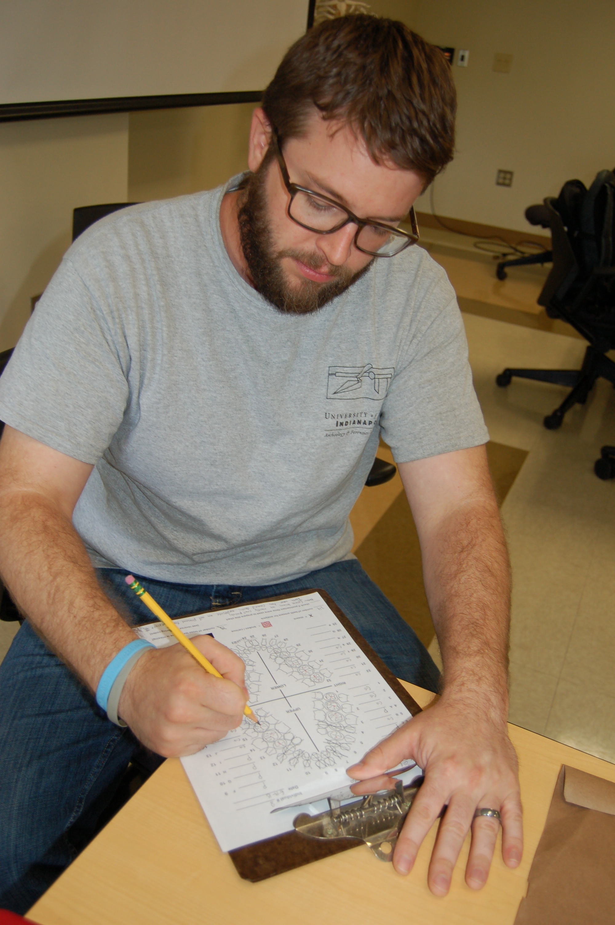 Team member Justin filling out a dental analysis form 