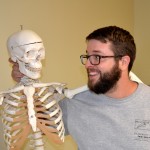 UIndy graduate student Justin with a skeleton model