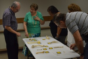 Local authorities standing over the bone quiz, multiple bones laid out with numbers above them.