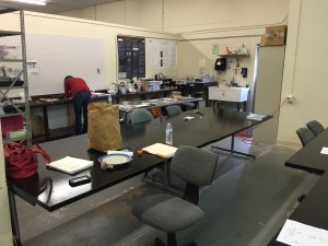 Laboratory space at the Grady Early Forensic Anthropology Research Lab with a large white board and tables with office materials