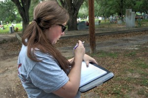 Erica looking down at her clipboard with pencil in hand