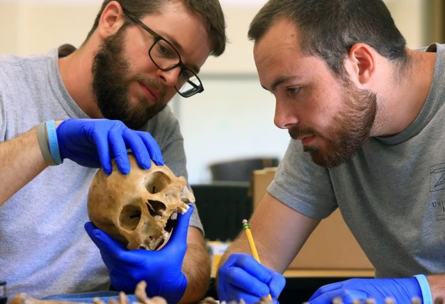 Photo of Ryan & Justin performing skeletal analysis on a cranium by Corpus Christi Caller Times