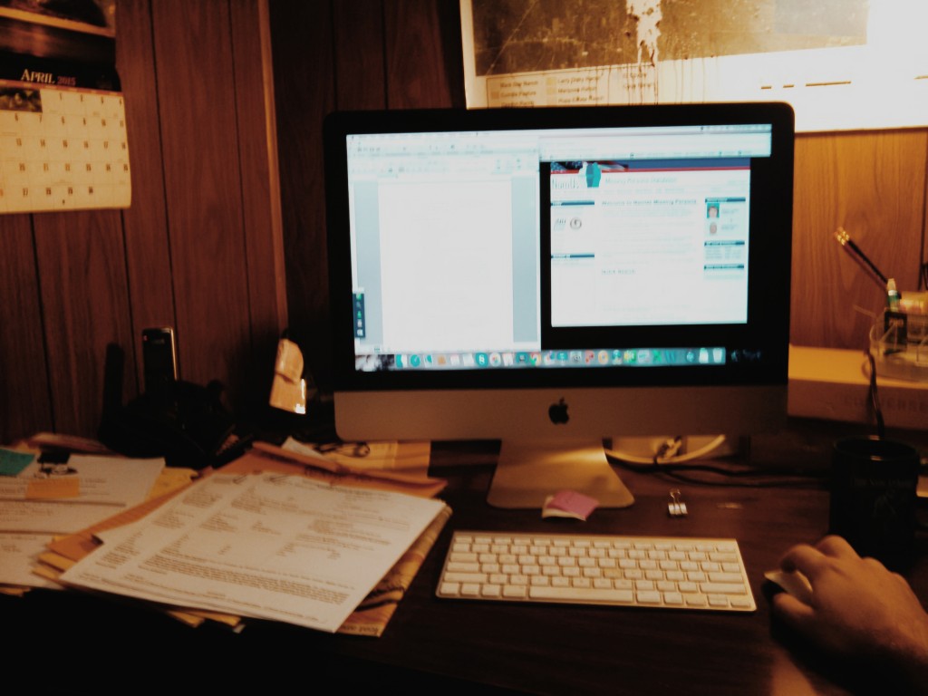 Ryan's work station with a computer and some paperwork