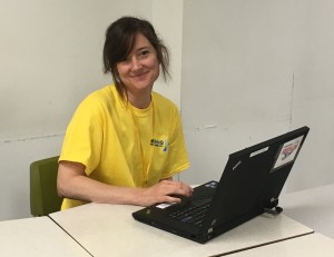 A smiling woman with a laptop