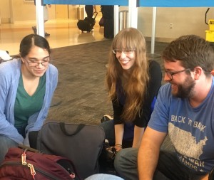 Three people sitting on a floor