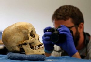 Justin taking a photo of a skull