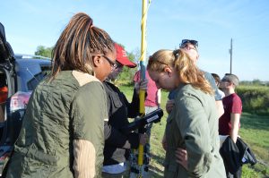 Team members using a Total Station