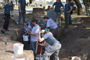 Team members working in a trench.