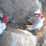 Two UIndy team members working in a trench.