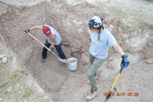 Two team members excavating a burial.