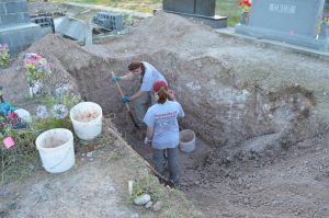 Team members digging a trench.