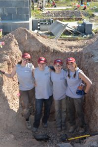 UIndy team standing in the bottom of an empty pit.