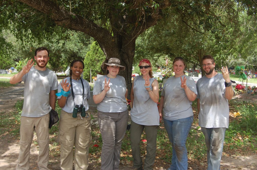 DAy three group picture with 3 fingers in the air