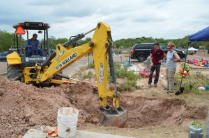 Backhoe digging a pit.