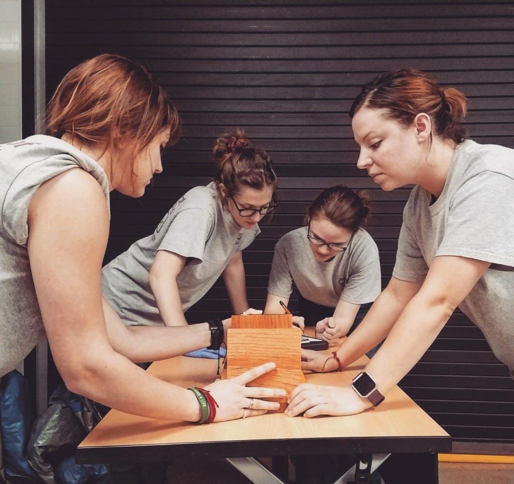 Team members measuring skeletal elements in the lab.