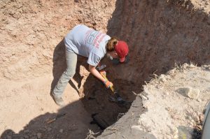 Team member excavating a burial.