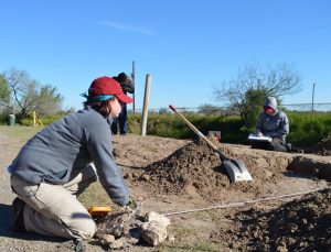 Team members mapping in a trench.