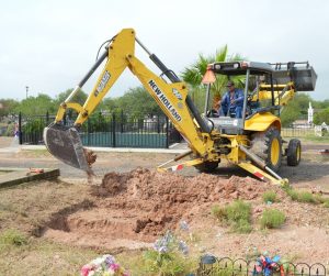 Back hoe digging a trench.