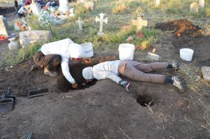 Team members excavating a burial.