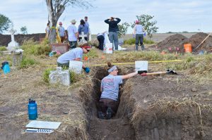 Team members uncovering a burial.